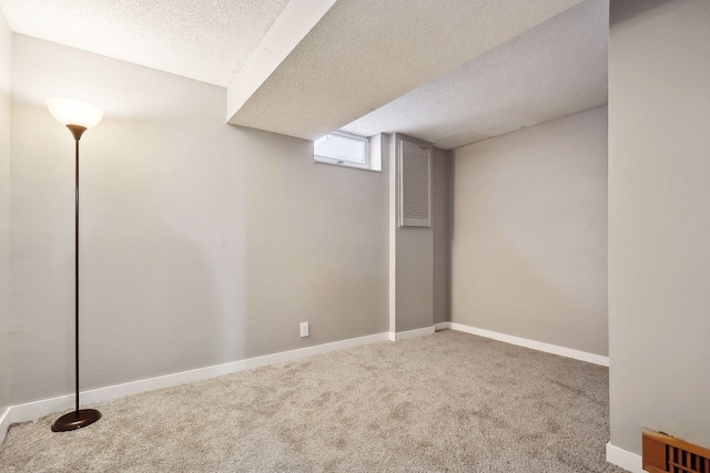 basement with a textured ceiling and carpet flooring