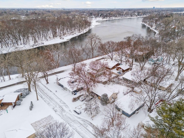 snowy aerial view featuring a water view