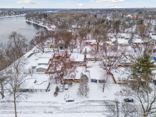 snowy aerial view with a water view