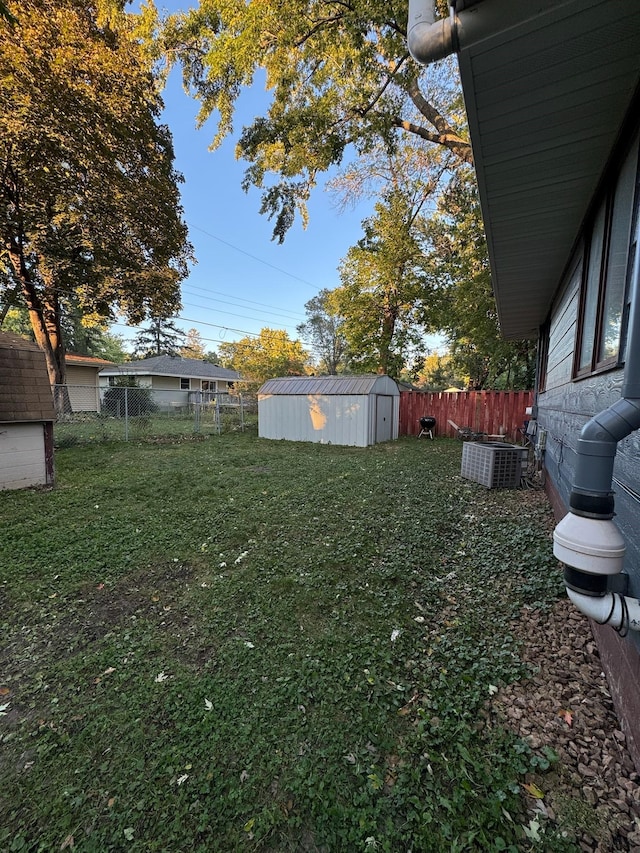 view of yard with cooling unit and a storage unit