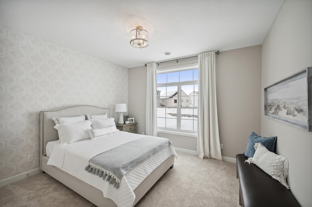 carpeted bedroom with a notable chandelier