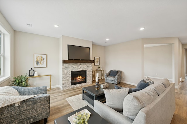 4532 86th St NE, Monticello, MN 55362 - living area featuring a fireplace, baseboards, light wood-style floors, and recessed lighting