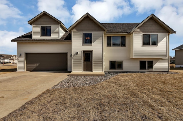 view of front facade with concrete driveway and a front lawn