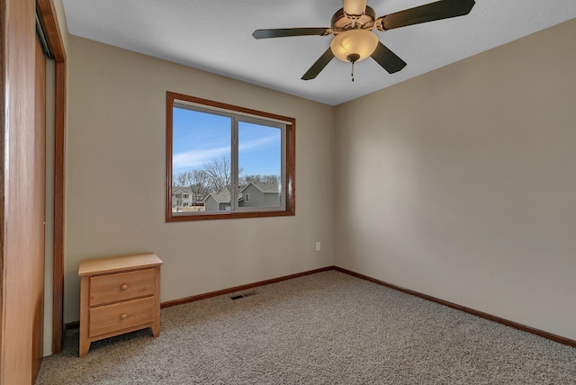 unfurnished bedroom featuring visible vents, ceiling fan, baseboards, light carpet, and a closet