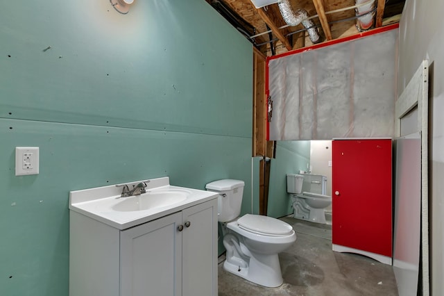 bathroom with unfinished concrete flooring, toilet, and vanity