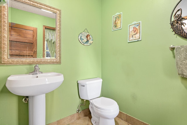 bathroom with tile patterned flooring and toilet