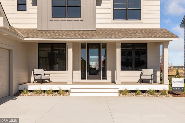 view of exterior entry featuring covered porch