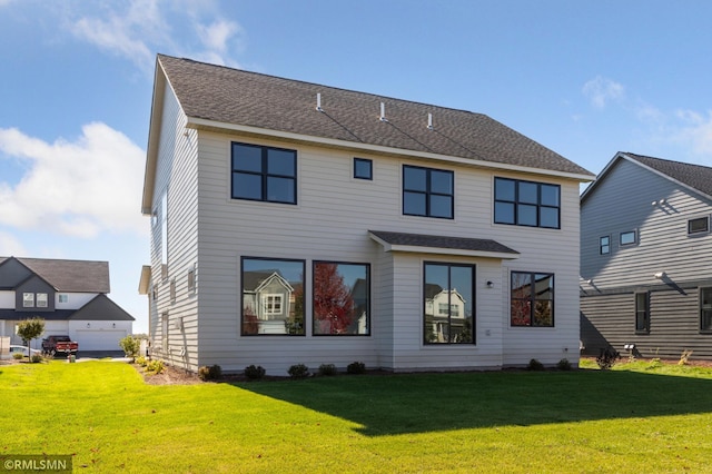 rear view of house featuring a yard