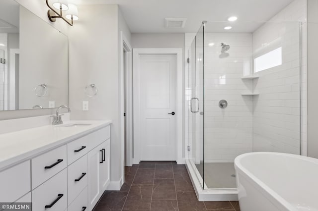 bathroom with tile patterned flooring, vanity, and independent shower and bath