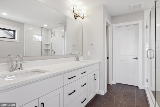 bathroom featuring tile patterned flooring, vanity, and an enclosed shower