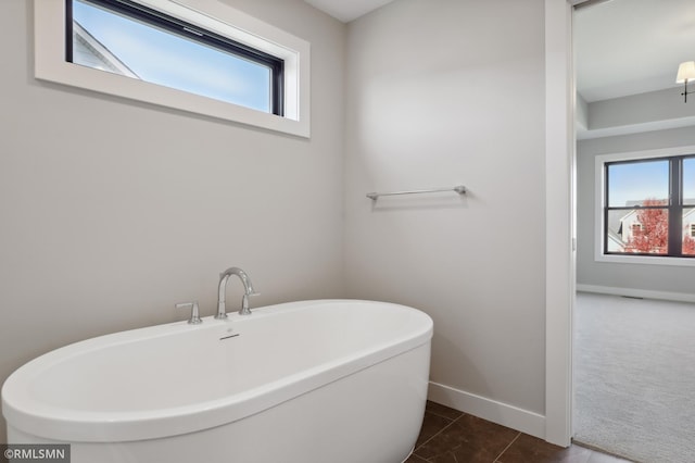 bathroom featuring tile patterned floors and a tub