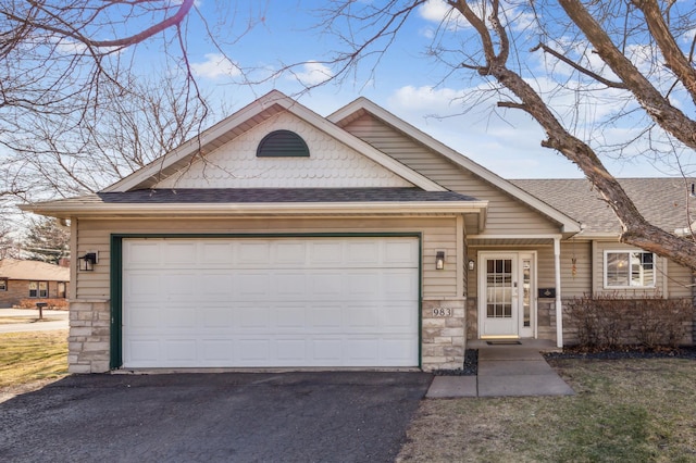 983 County Road D E, Vadnais Heights, MN 55109 - ranch-style house with an attached garage, stone siding, driveway, and roof with shingles