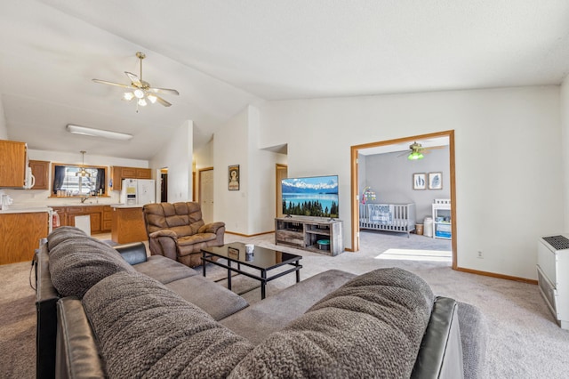 983 County Road D E, Vadnais Heights, MN 55109 - living room featuring light colored carpet, ceiling fan, baseboards, and vaulted ceiling