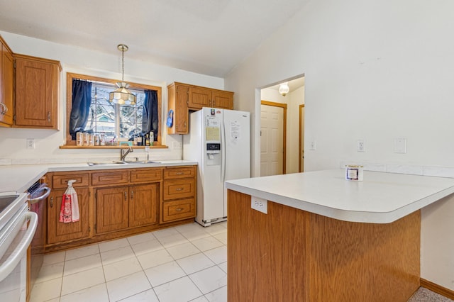 983 County Road D E, Vadnais Heights, MN 55109 - kitchen featuring brown cabinetry, white refrigerator with ice dispenser, a sink, and a peninsula