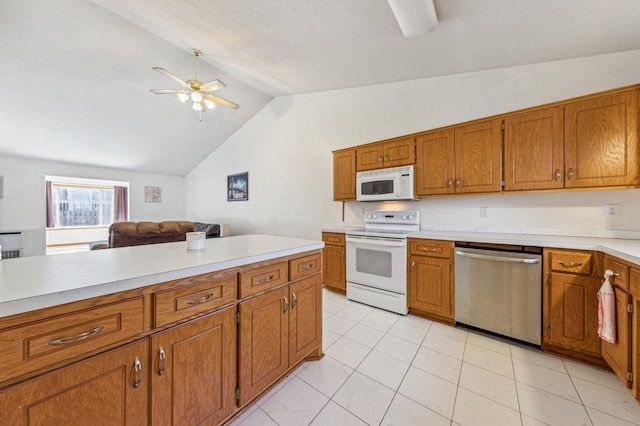 983 County Road D E, Vadnais Heights, MN 55109 - kitchen with vaulted ceiling, white appliances, light countertops, brown cabinetry, and ceiling fan