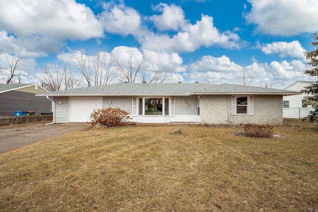 ranch-style home with a garage and a front lawn