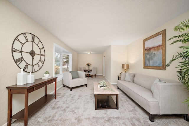 living room with a textured ceiling and light colored carpet