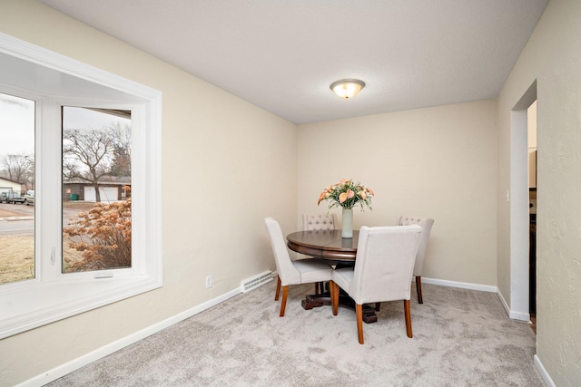 dining space featuring light colored carpet