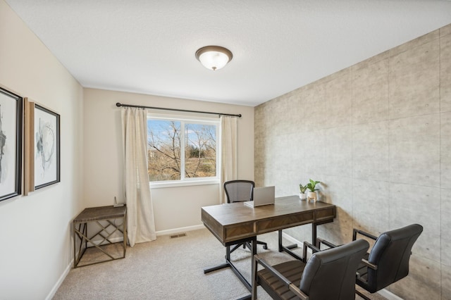 office area featuring a textured ceiling, light colored carpet, and tile walls