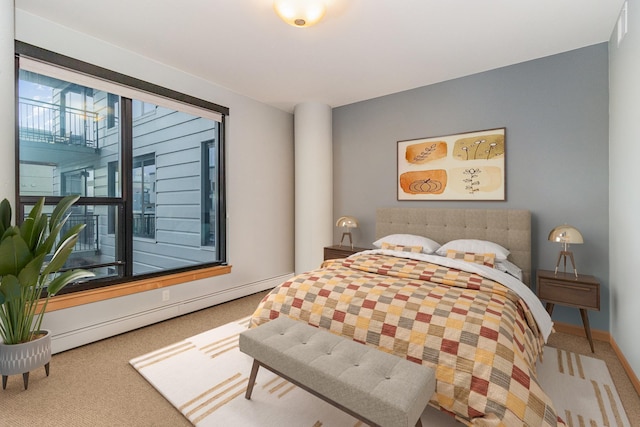 bedroom featuring carpet and a baseboard heating unit