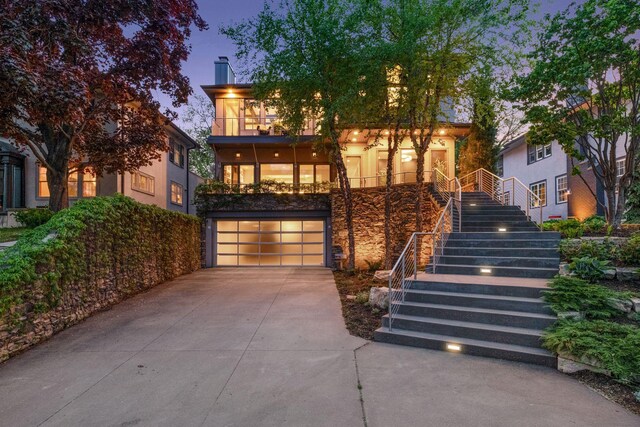 4540 Upton Ave S, Minneapolis, MN 55410 - view of front of home with stairway, driveway, a garage, a chimney, and stone siding