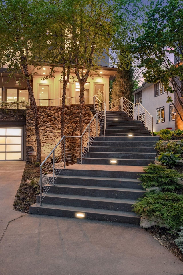 4540 Upton Ave S, Minneapolis, MN 55410 - view of front of home featuring stairway, stone siding, and concrete driveway