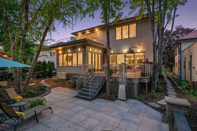 4540 Upton Ave S, Minneapolis, MN 55410 - back of house featuring a balcony, a patio, stucco siding, and a wooden deck
