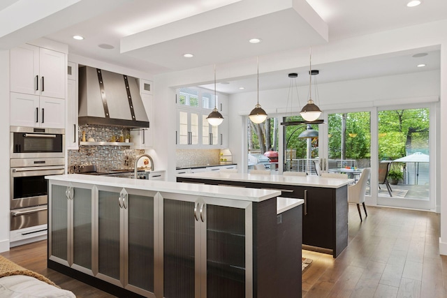 4540 Upton Ave S, Minneapolis, MN 55410 - kitchen with a spacious island, wall chimney range hood, double oven, a warming drawer, and recessed lighting