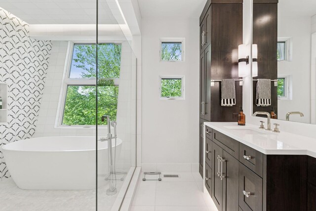 4540 Upton Ave S, Minneapolis, MN 55410 - full bath featuring tile patterned flooring, vanity, a soaking tub, and plenty of natural light