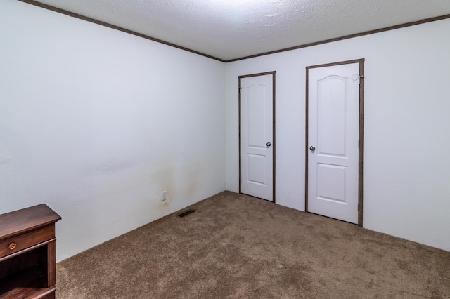 unfurnished bedroom with carpet and a textured ceiling