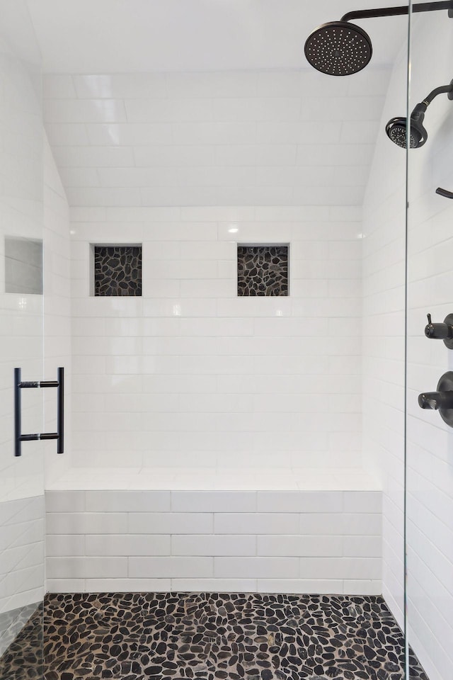 bathroom with lofted ceiling and a shower with shower door