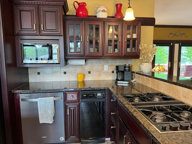 kitchen with pendant lighting, decorative backsplash, crown molding, and appliances with stainless steel finishes