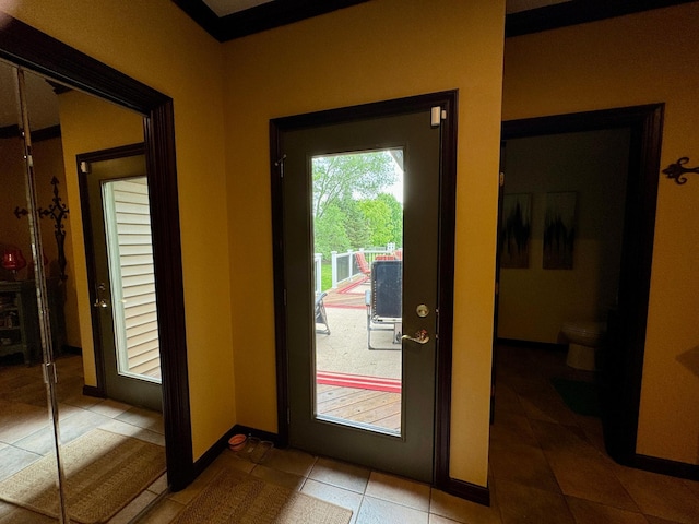 doorway to outside featuring tile patterned flooring