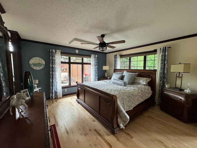 bedroom featuring a textured ceiling, light hardwood / wood-style floors, ceiling fan, and ornamental molding