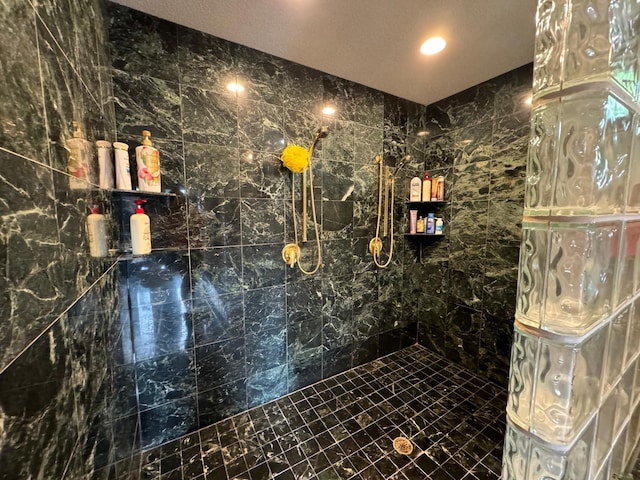 bathroom with a tile shower