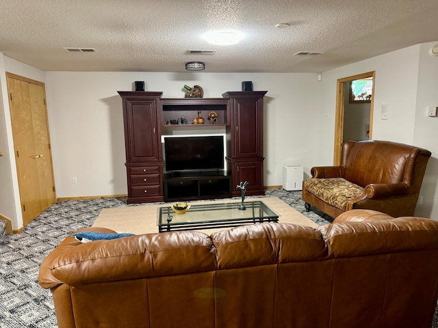 carpeted living room featuring a textured ceiling