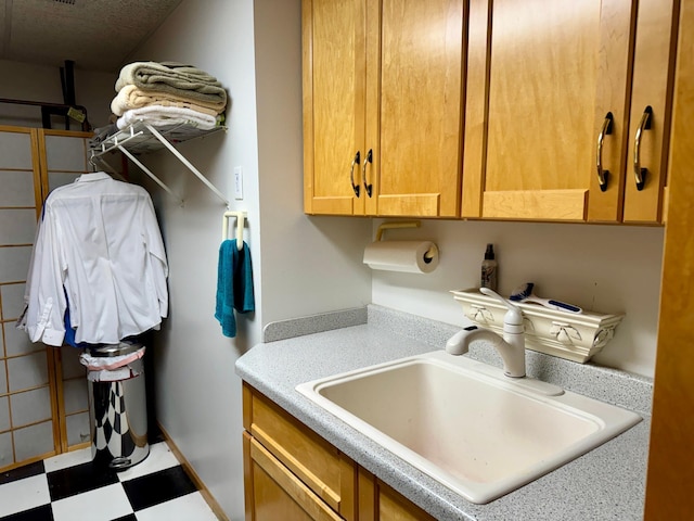 washroom featuring a textured ceiling and sink