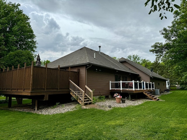 back of property with a yard and a wooden deck