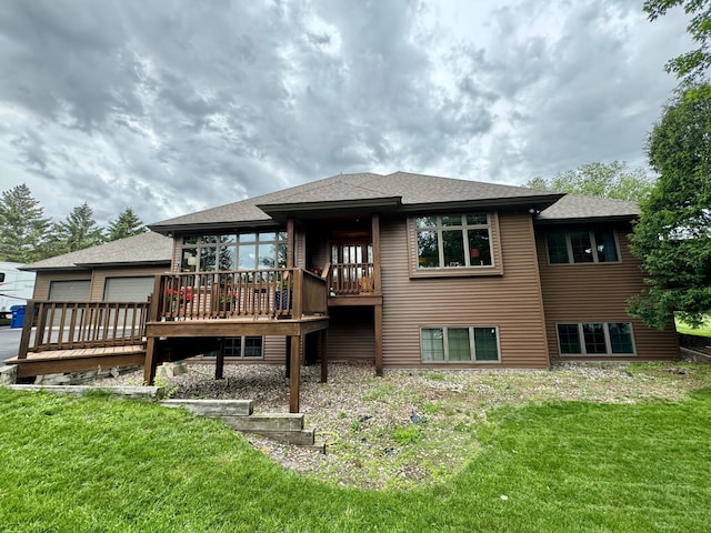 back of house featuring a lawn and a wooden deck