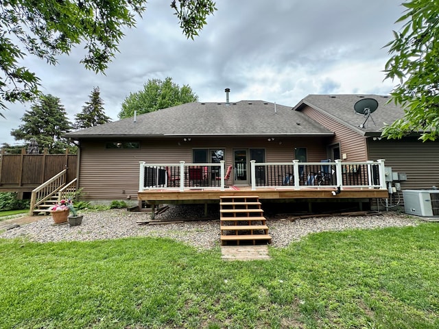 back of property with a yard, a deck, and cooling unit