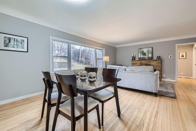 dining space with light hardwood / wood-style flooring