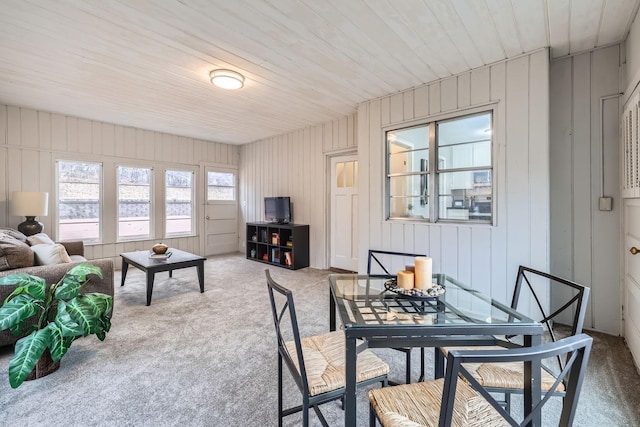 carpeted dining area with wood ceiling