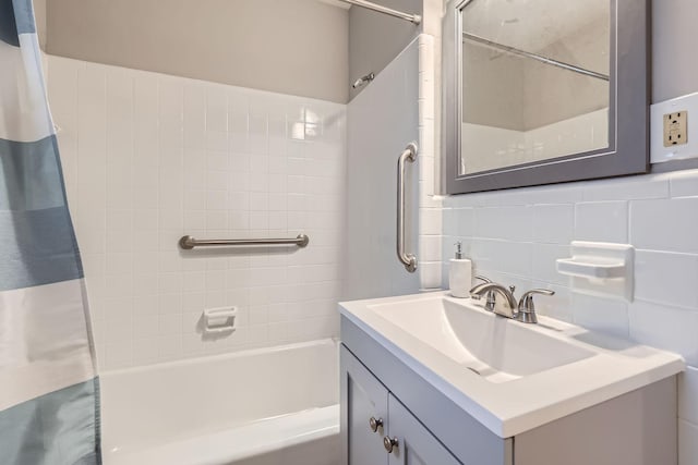 bathroom with vanity, shower / bath combo, and backsplash