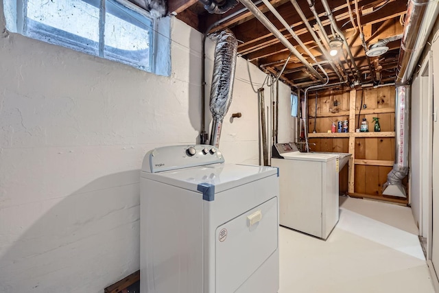 clothes washing area featuring separate washer and dryer