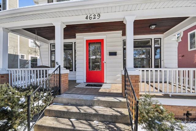 entrance to property featuring a porch