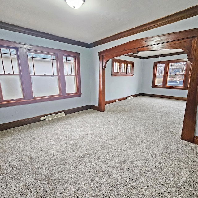 empty room featuring carpet and ornamental molding