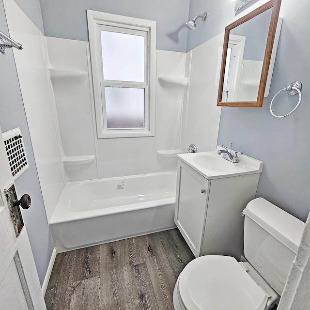 full bathroom with vanity, toilet, shower / bathing tub combination, and hardwood / wood-style flooring