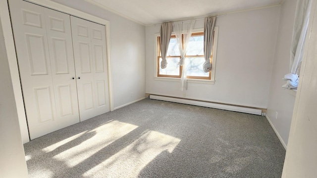 unfurnished bedroom featuring carpet floors, a baseboard radiator, and a closet