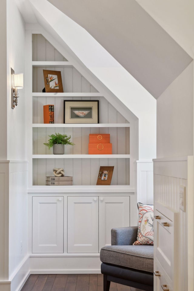 sitting room with built in features and dark wood-style flooring