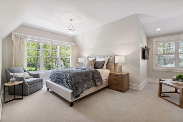 carpeted bedroom featuring multiple windows, vaulted ceiling, and baseboards